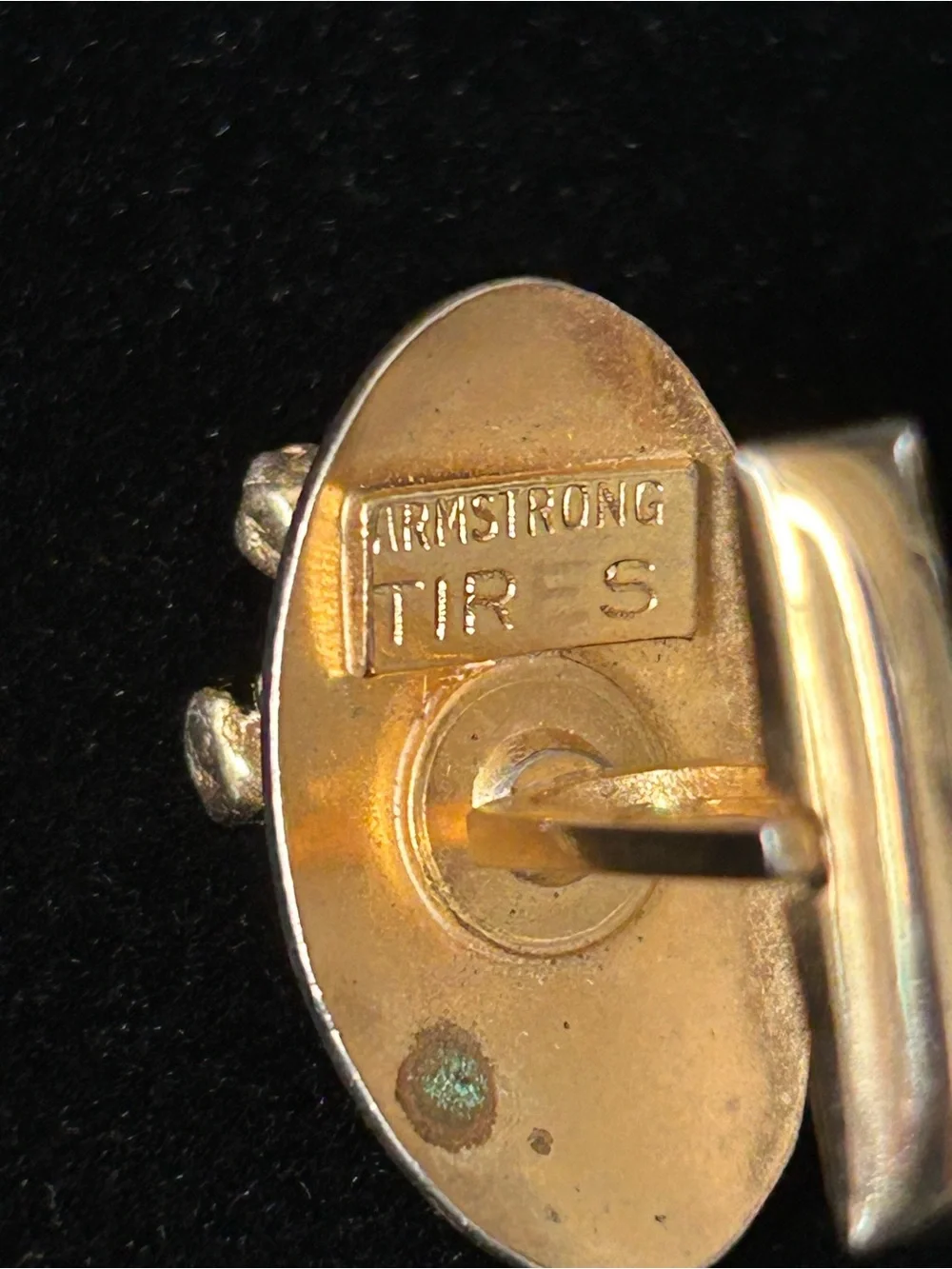 Rhinoceros gold tone cufflinks embossed with Armstrong Tires on the underneath.